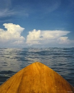 Nose of surfboard pointed at the horizon