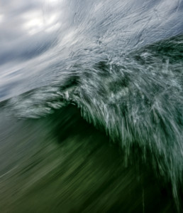 Blurry image of a breaking green wave.